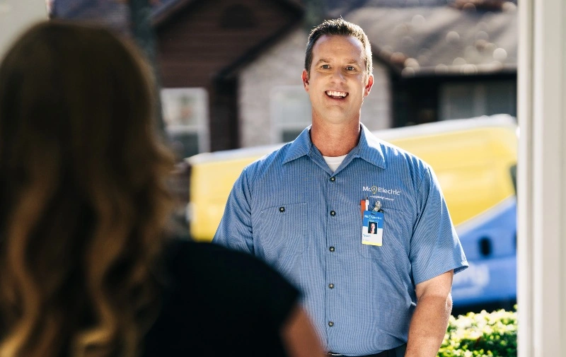 Mr. Electric emergency electrician greeting customer at their door